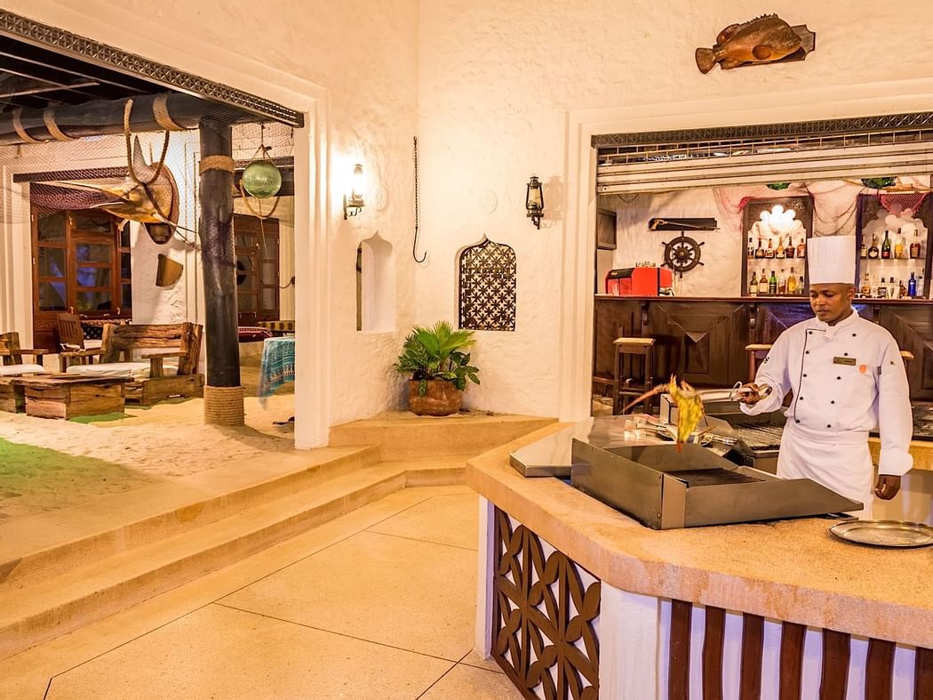 Chef cooking food in Jahazi Grill at Serena Beach Resort & Spa