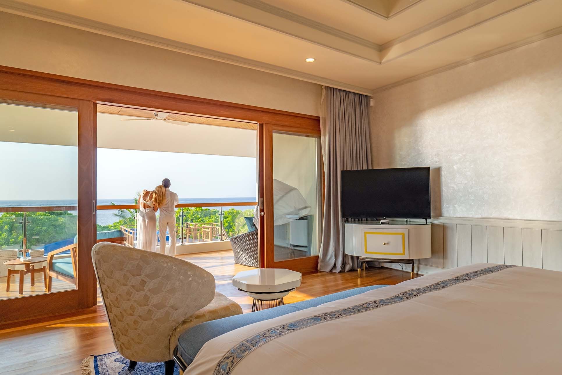 Couple relaxing on a balcony at The Signature Collection