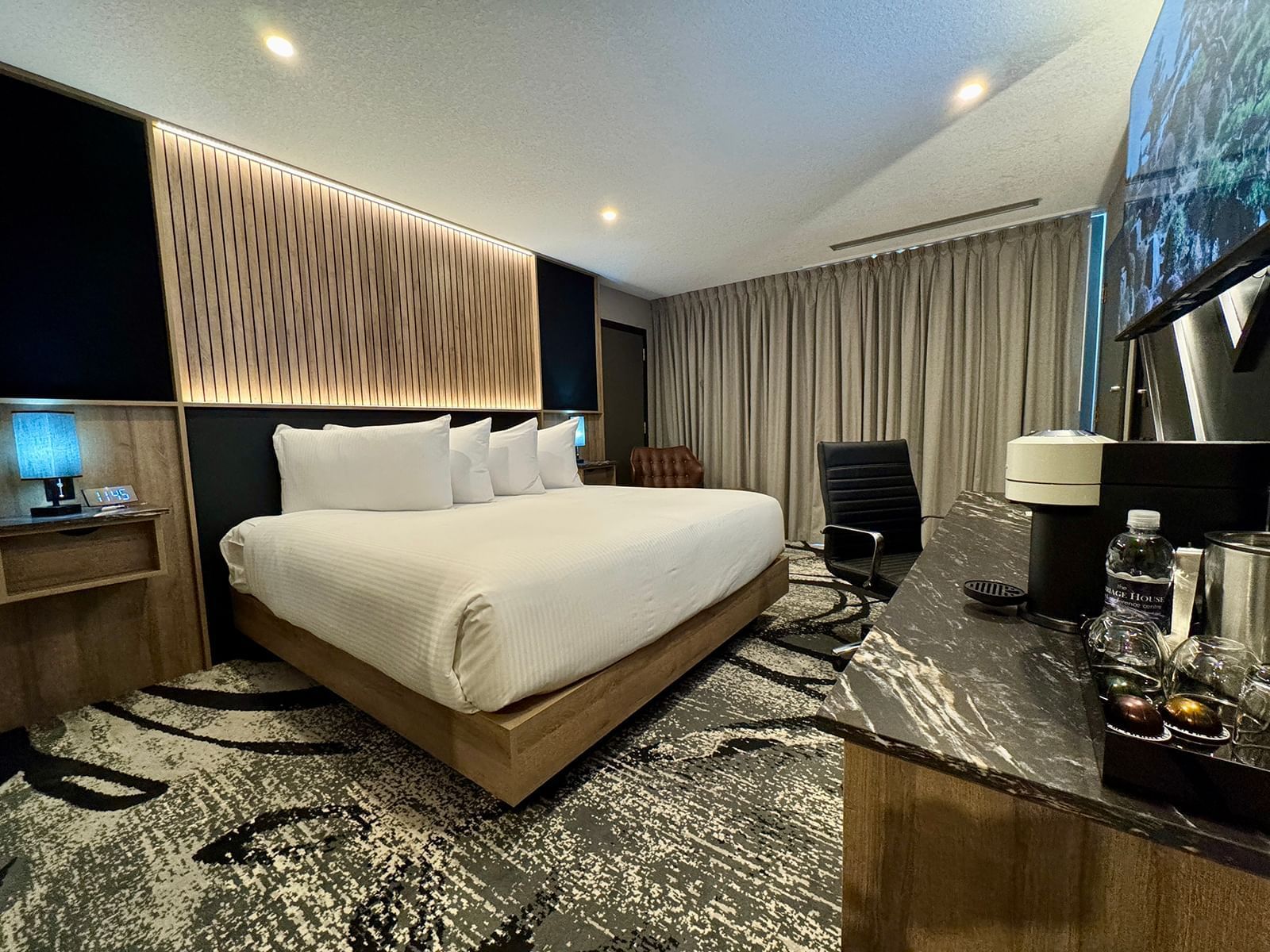 Executive King room with a large bed and modern amenities at Carriage House Hotel & Conference Centre, Calgary.