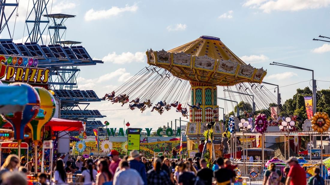 Crowded amusement park with rides and people at Sydney Royal Easter Show 2026.