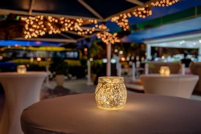 Burning candle on table in darkness at Amsterdam Manor Resort