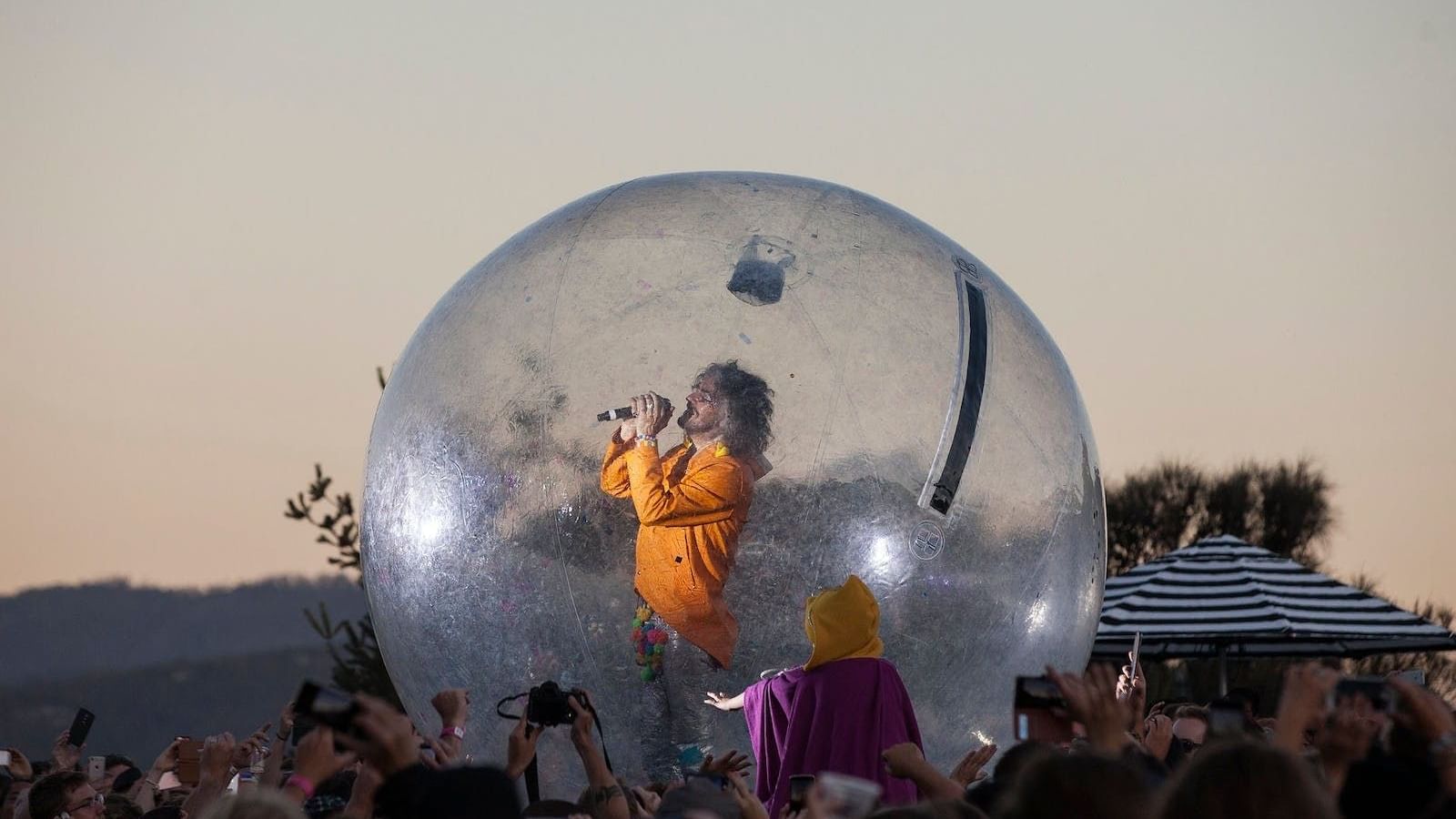 Singer performing amidst a crowd on a bubble at Mona Foma festival near Hotel Grand Chancellor Hobart