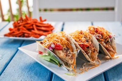 Close-up of tacos and crisps served on a table outdoors at Trianon Bonita Bay