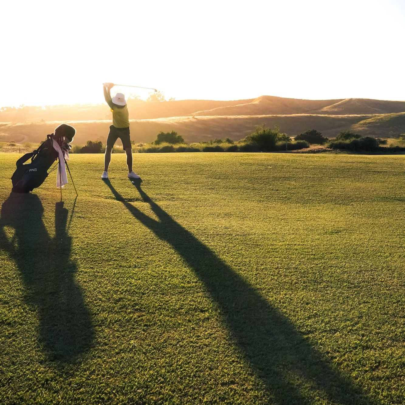 Landscape view of a woman standing on the golf course at dawn, Selman Marrakech