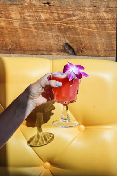 Close-up of lady holding a mocktail at The Verb Hotel