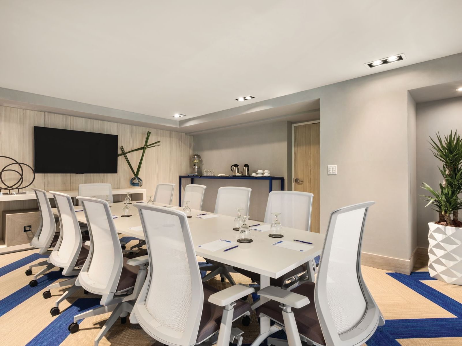 meeting room with conference table, chairs and television