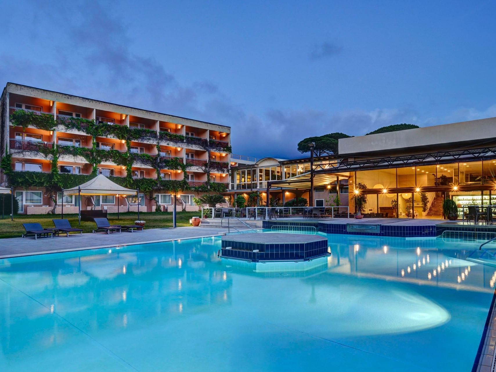 Outdoor pool area & hotel exterior view at Golf Hotel Punta Ala