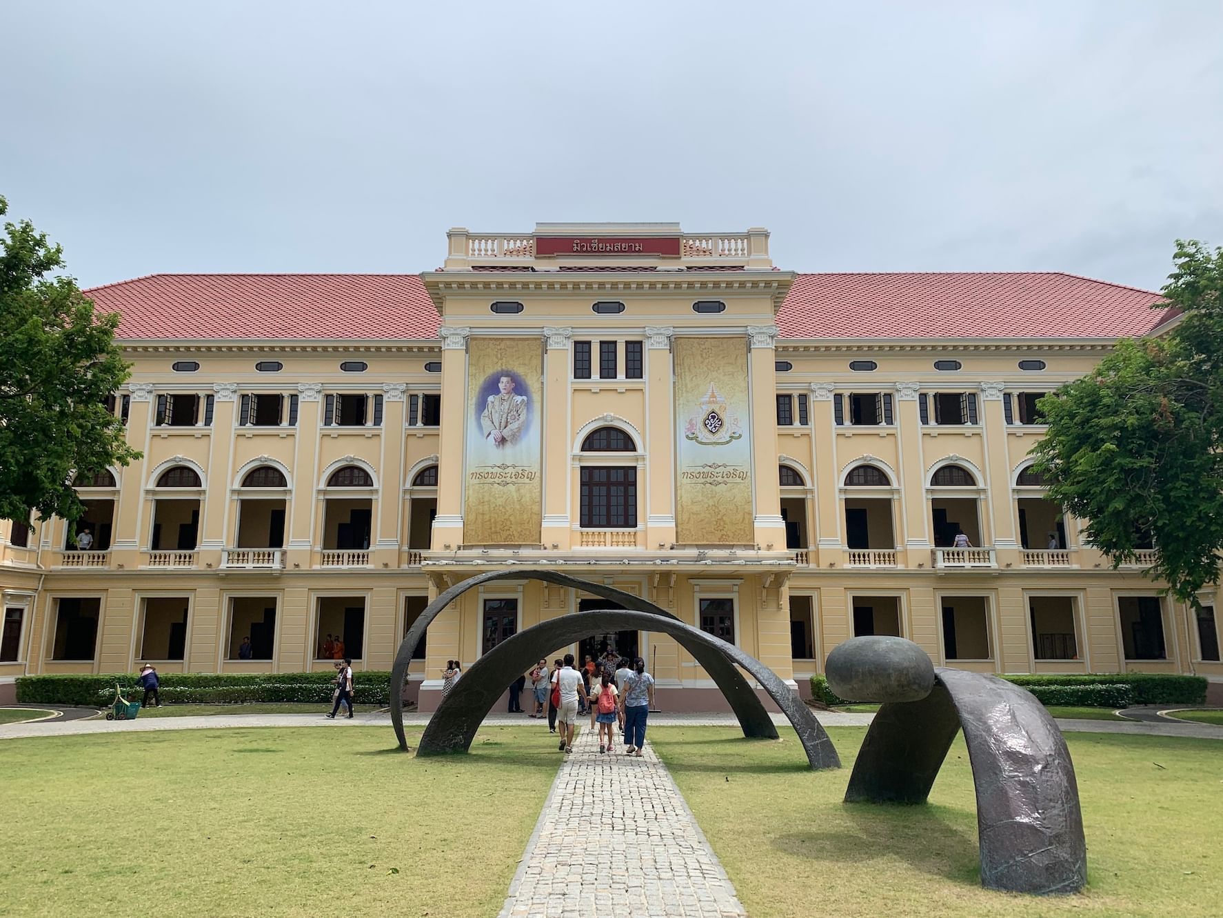 Museum Siam with modern sculptures in front, and visitors walking along a stone path near The Okura Prestige Bangkok