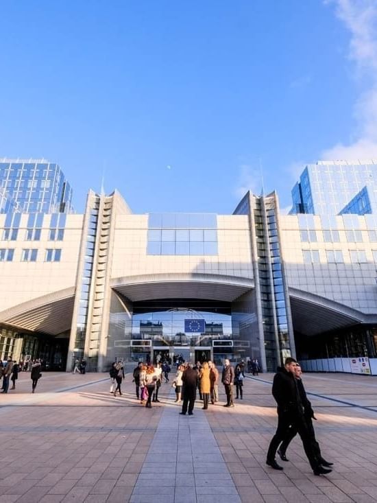 Exterior view of Parlamentarium, surrounded by walking guests near Warwick Grand Place Brussels