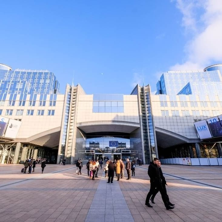 Exterior view of Parlamentarium, surrounded by walking guests near Warwick Grand Place Brussels