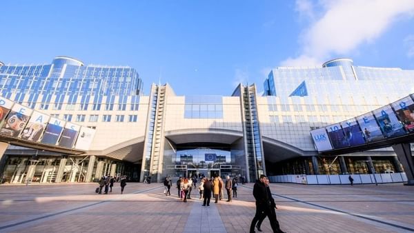 Exterior view of Parlamentarium, surrounded by walking guests near Warwick Grand Place Brussels
