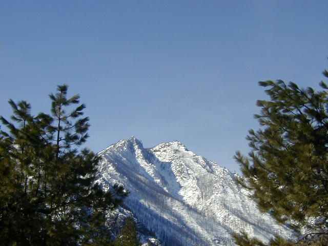 Sun lighting up the snow covered mountains near Sleeping Lady