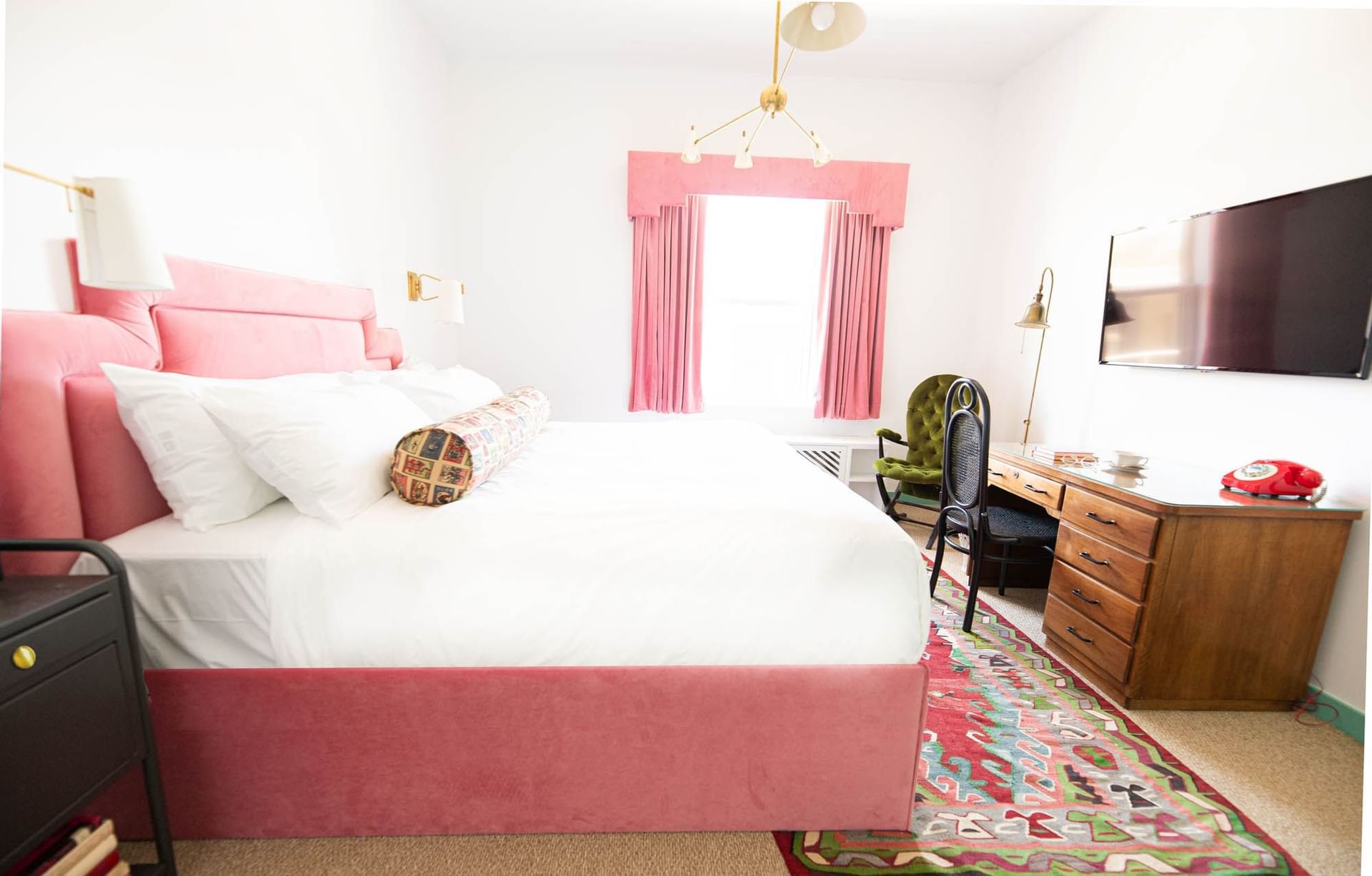 bed with pink bedframe in white room