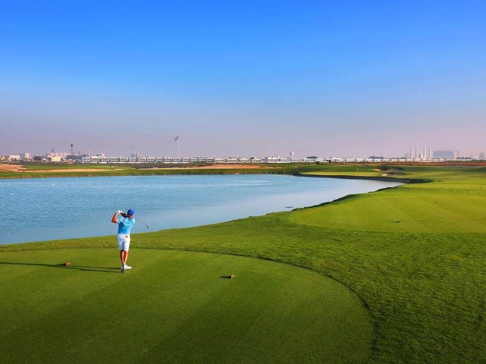 A man playing golf in Al Zorah golf ground at Ajman Hotel