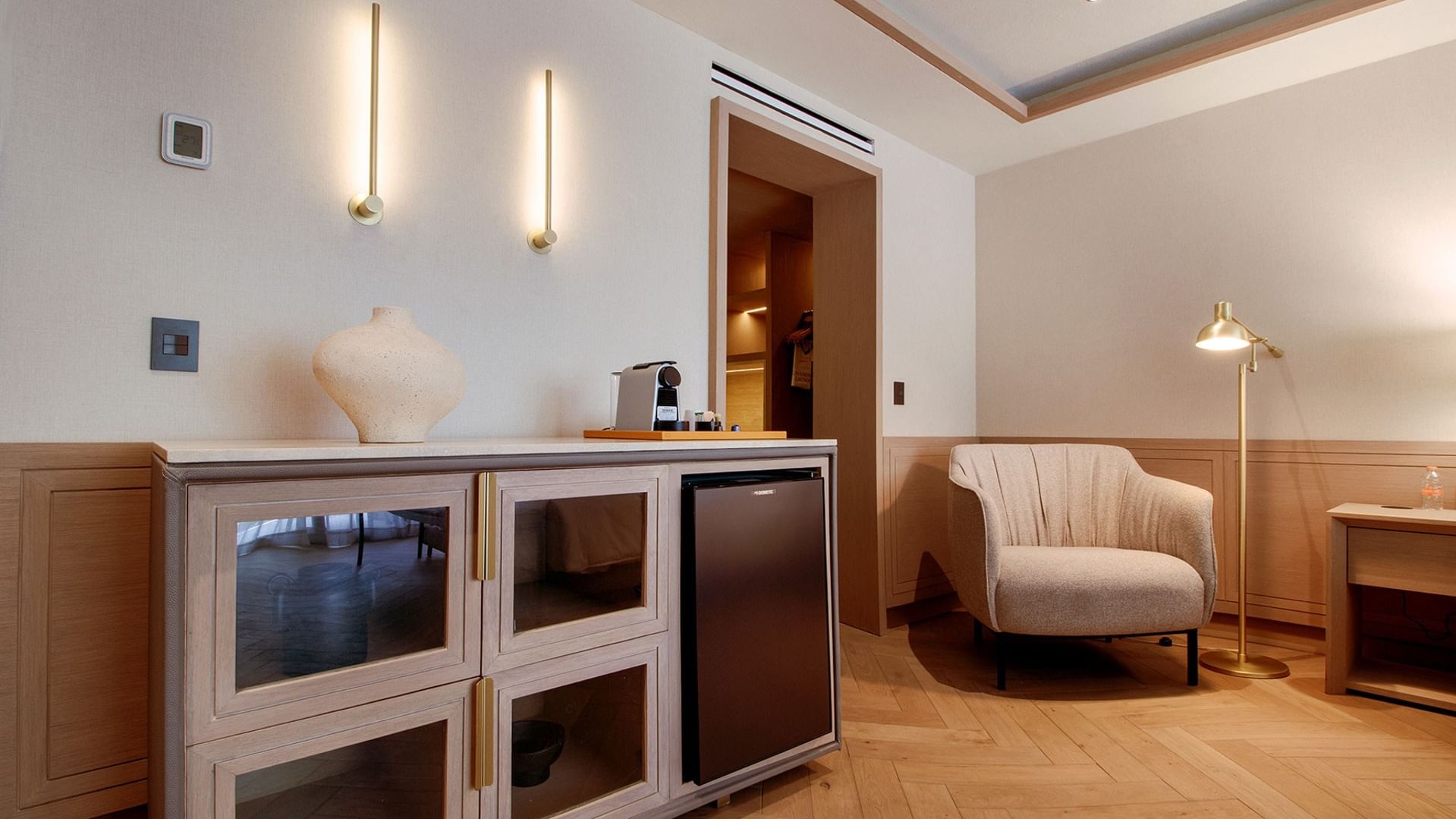 King Superior Viceroys Suite featuring a stylish credenza, mini-fridge, and cozy lounge chair at Camino Real Polanco Mexico