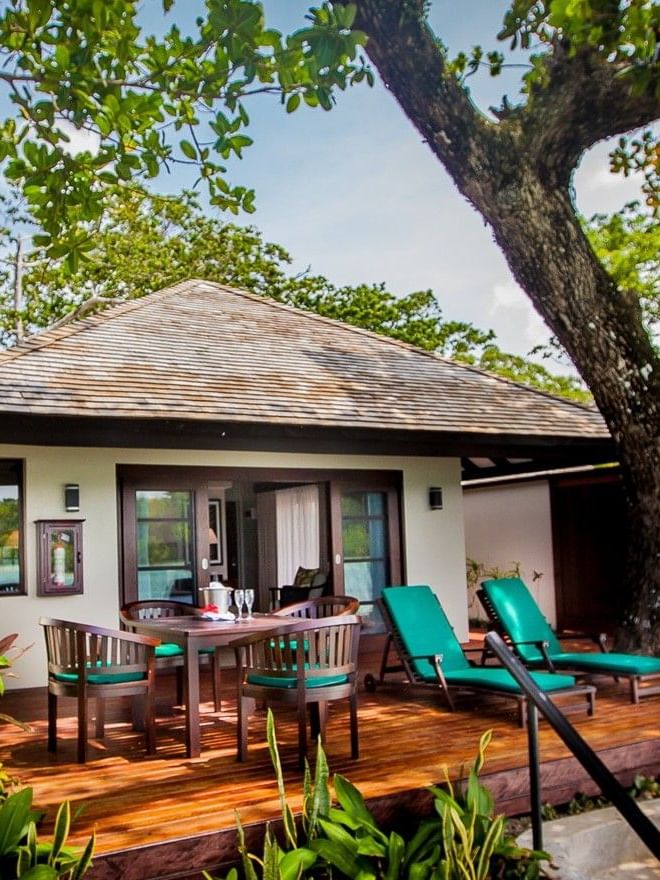 Private wooden deck with patio seating, and teal lounge chairs in Shefa Pool Villa at warwick le lagon-vanuatu