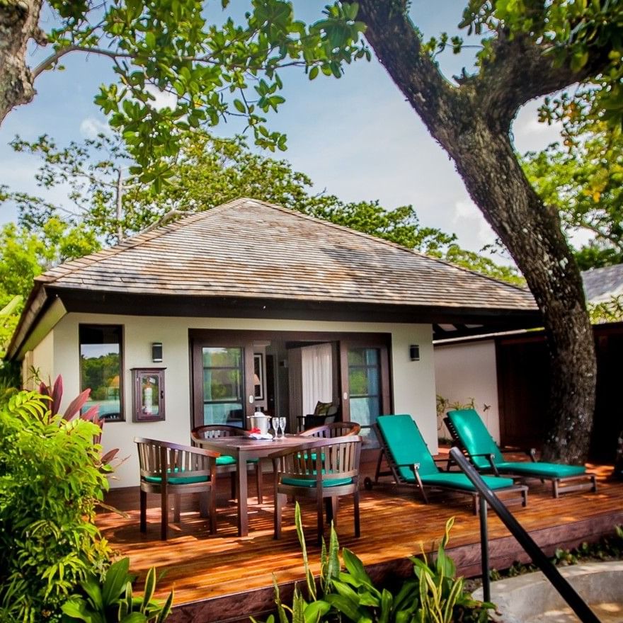 Private wooden deck with patio seating, and teal lounge chairs in Shefa Pool Villa at warwick le lagon-vanuatu