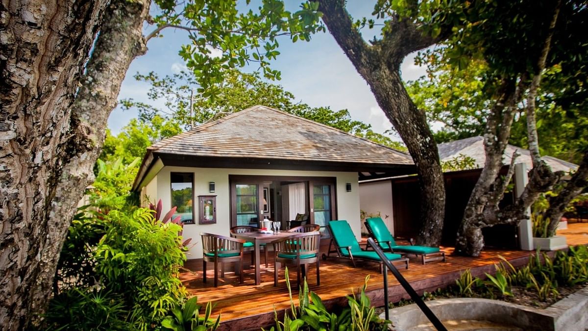Private wooden deck with patio seating, and teal lounge chairs in Shefa Pool Villa at warwick le lagon-vanuatu
