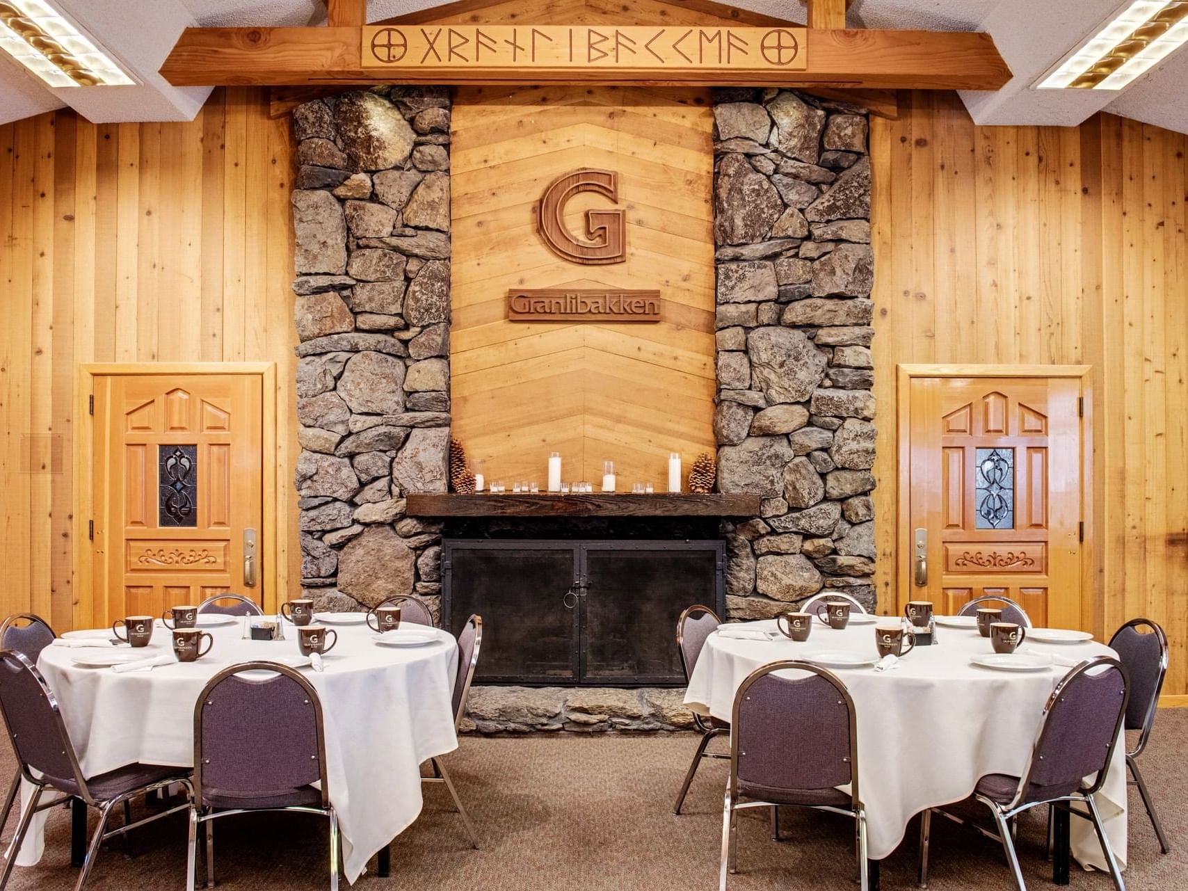 Dining tables, fireplace in Gran hall at Granlibakken Tahoe