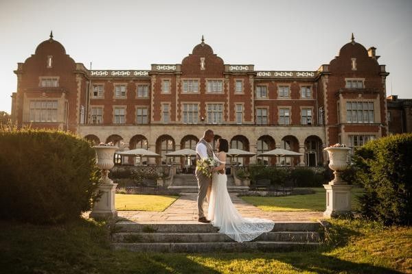Bride and groom outside of Easthampstead Park after securing their venue at wedding showcase