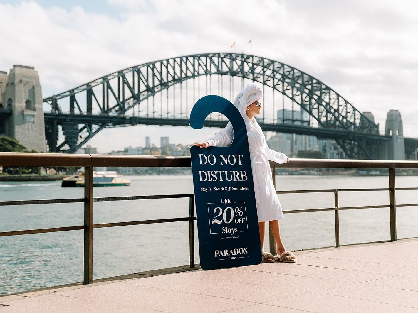 Woman holding large question mark sign advertising 20% off stays on Paradox sign.
