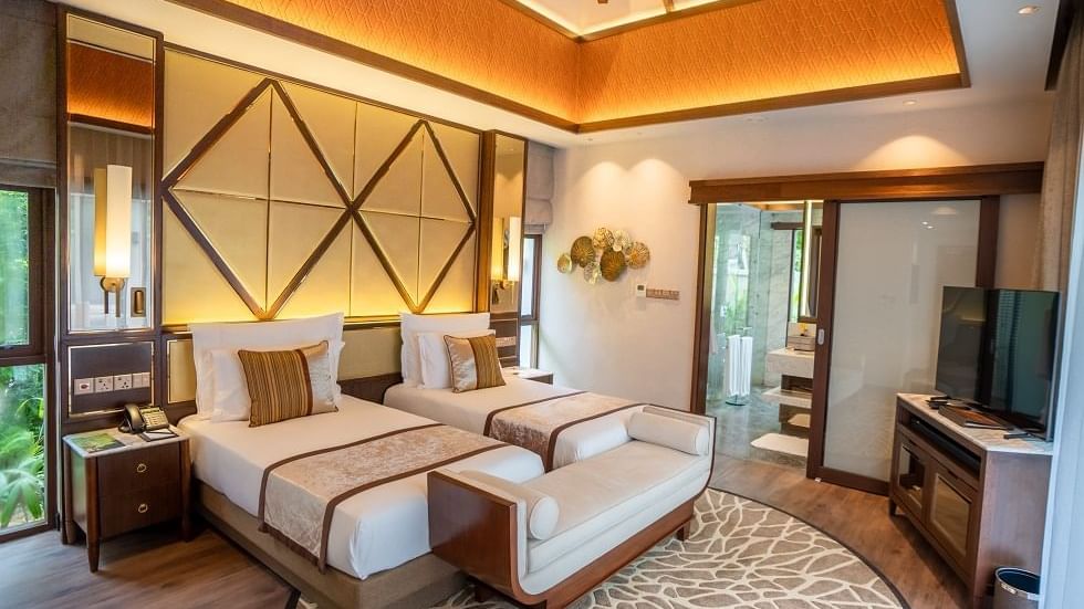 Spacious Royal Villa bedroom with twin beds, geometric headboard, and warm lighting at The Banjaran Hotsprings Retreat, Ipoh