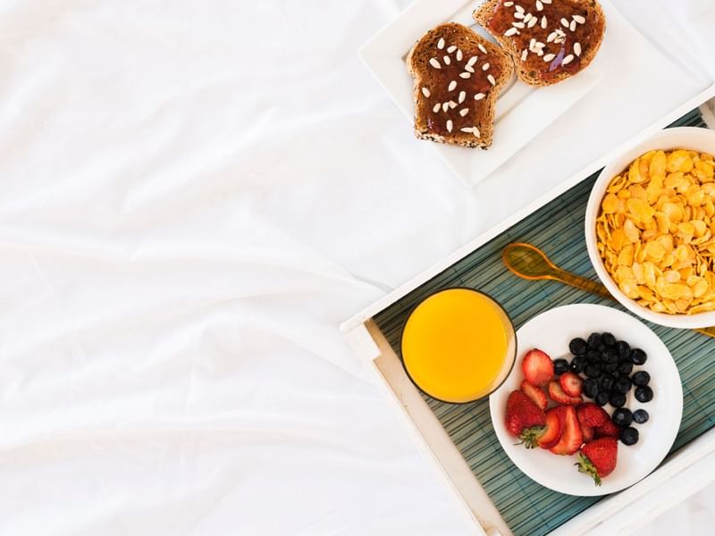A food tray served on a bed in a room at Sunway Putra Hotel