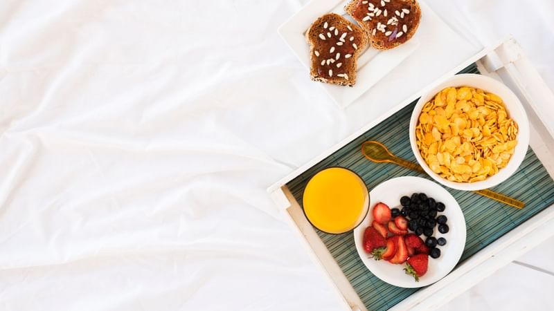 A food tray served on a bed in a room at Sunway Putra Hotel