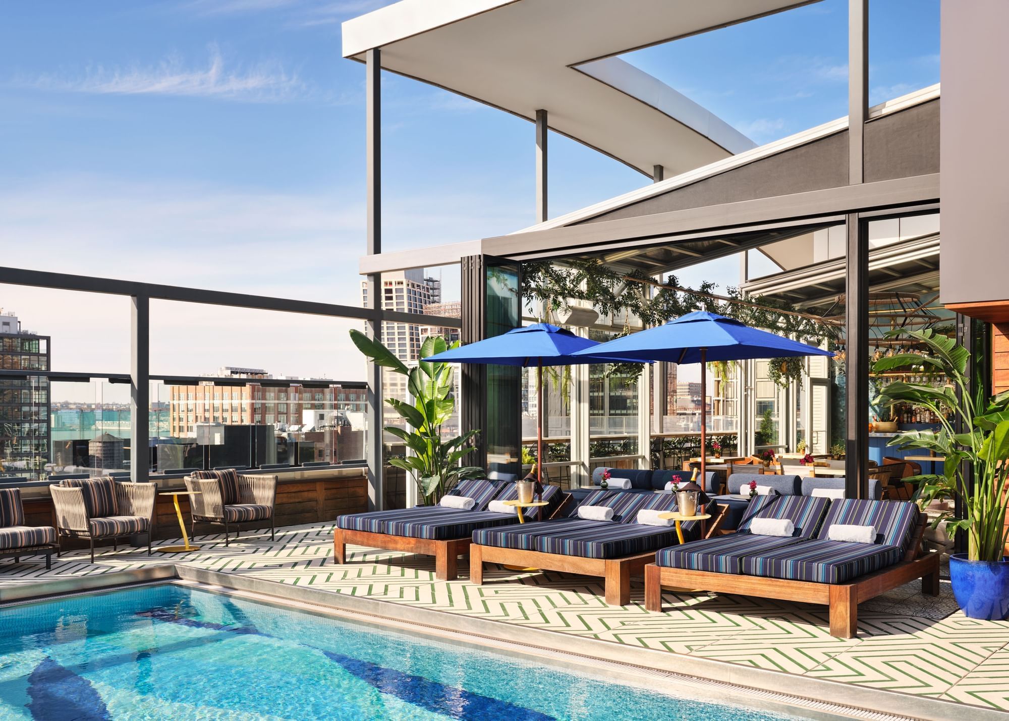 Rooftop pool area with daybed lounge chairs 