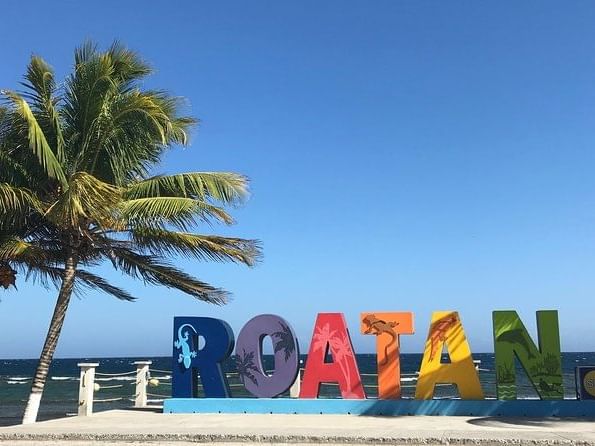 Channel letter sign of ROATAN by the beach near Infinity Bay