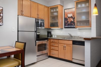 small kitchen with fridge, oven and dishwasher