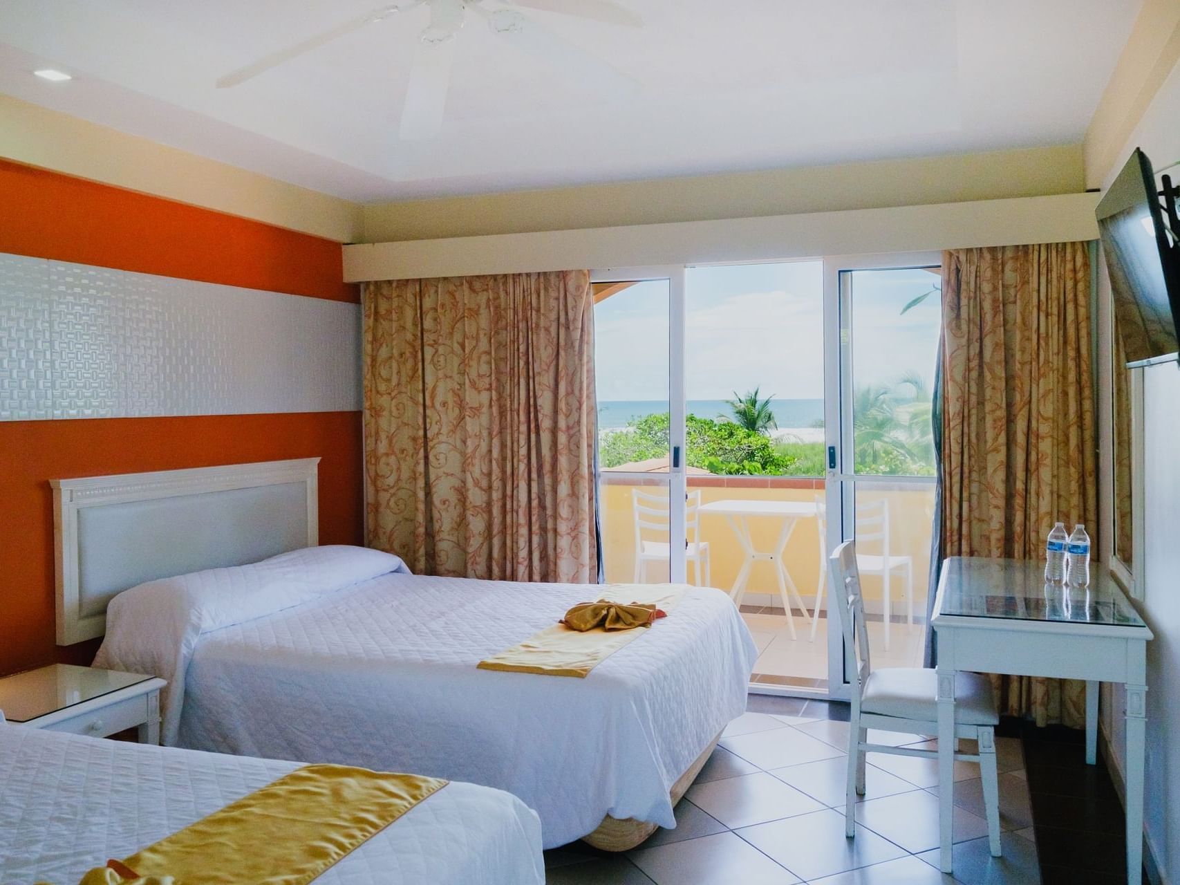 TV & work desk facing the beds in Oceanfront Two Queen Beds with Balcony at Las Olas Beach Resort