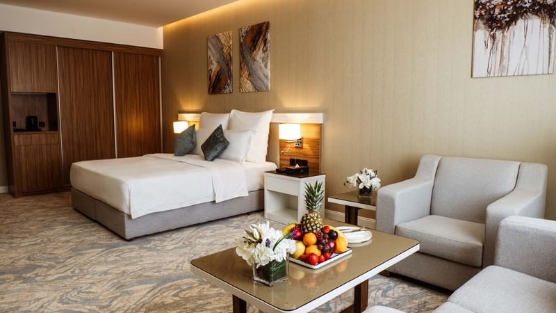 Table with fruits with cozy bed in Accessible room at Cantonal Hotel by Warwick Riyadh