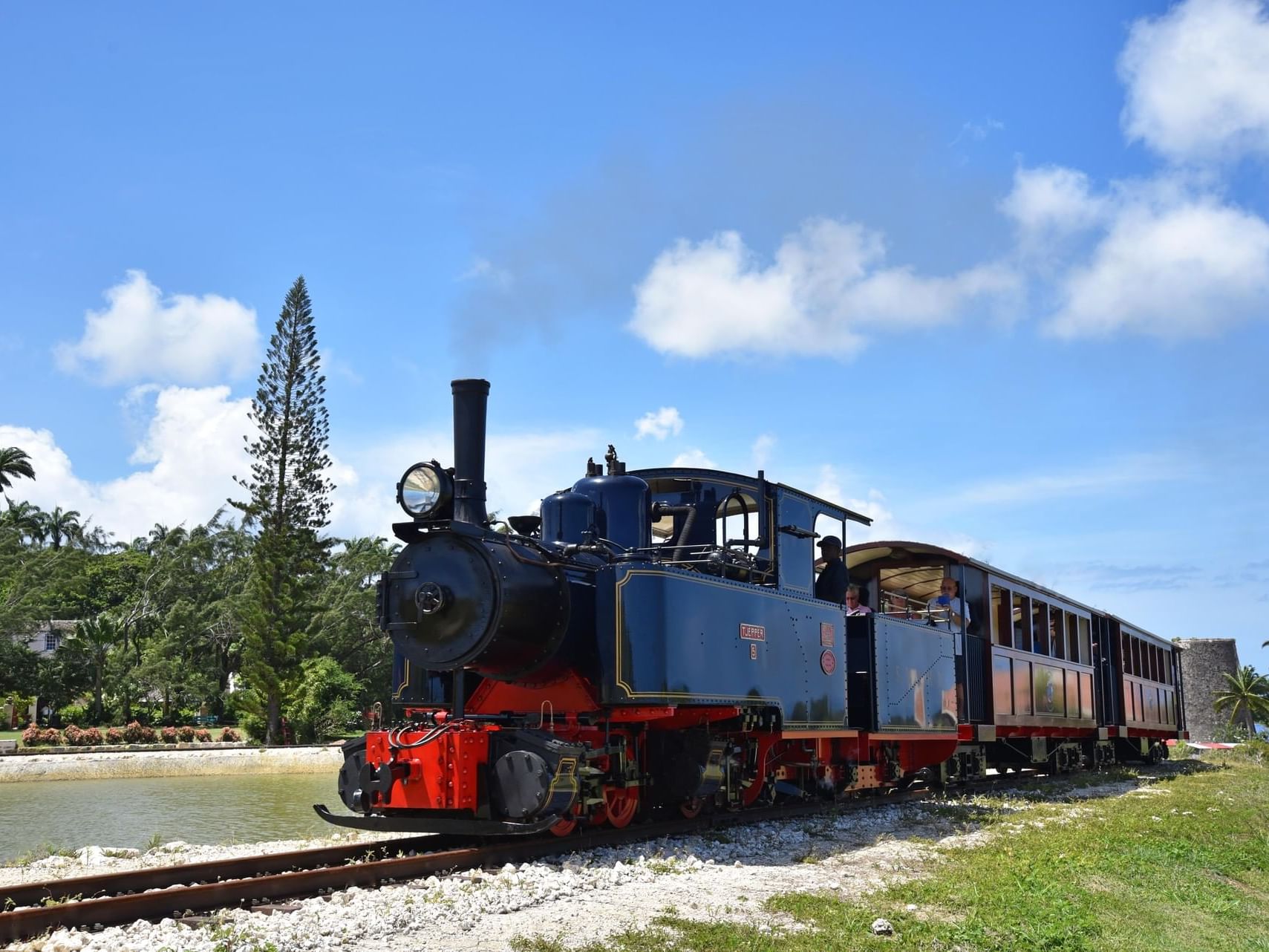 Steam train on a riverbank tracks near Bougainvillea Barbados