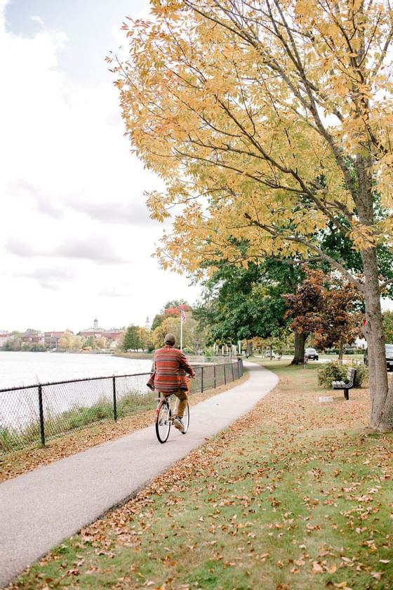 A man riding a bike on a Pathway near The Exeter Inn