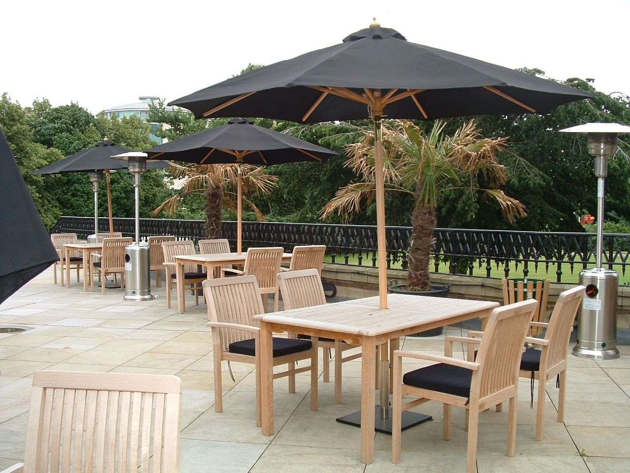 Outdoor patio with tables, chairs, umbrellas, and heaters at The Milner York featuring Summer Party hotel deals in York