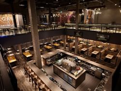 The Rec Room restaurant interior with a bar and dining tables set up near Acclaim Hotel Calgary