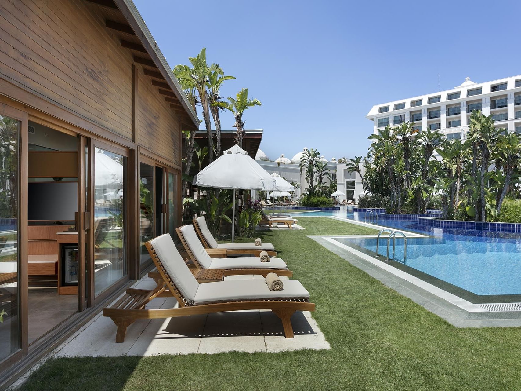 Outdoor pool area and sunbeds in Bali House Garden at Titanic Deluxe Golf Belek