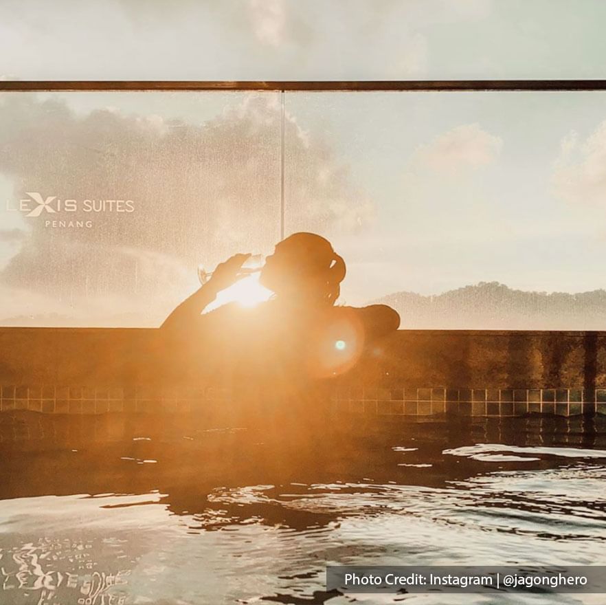 A man is swimming in Lexis Suites Penang’s private pool.