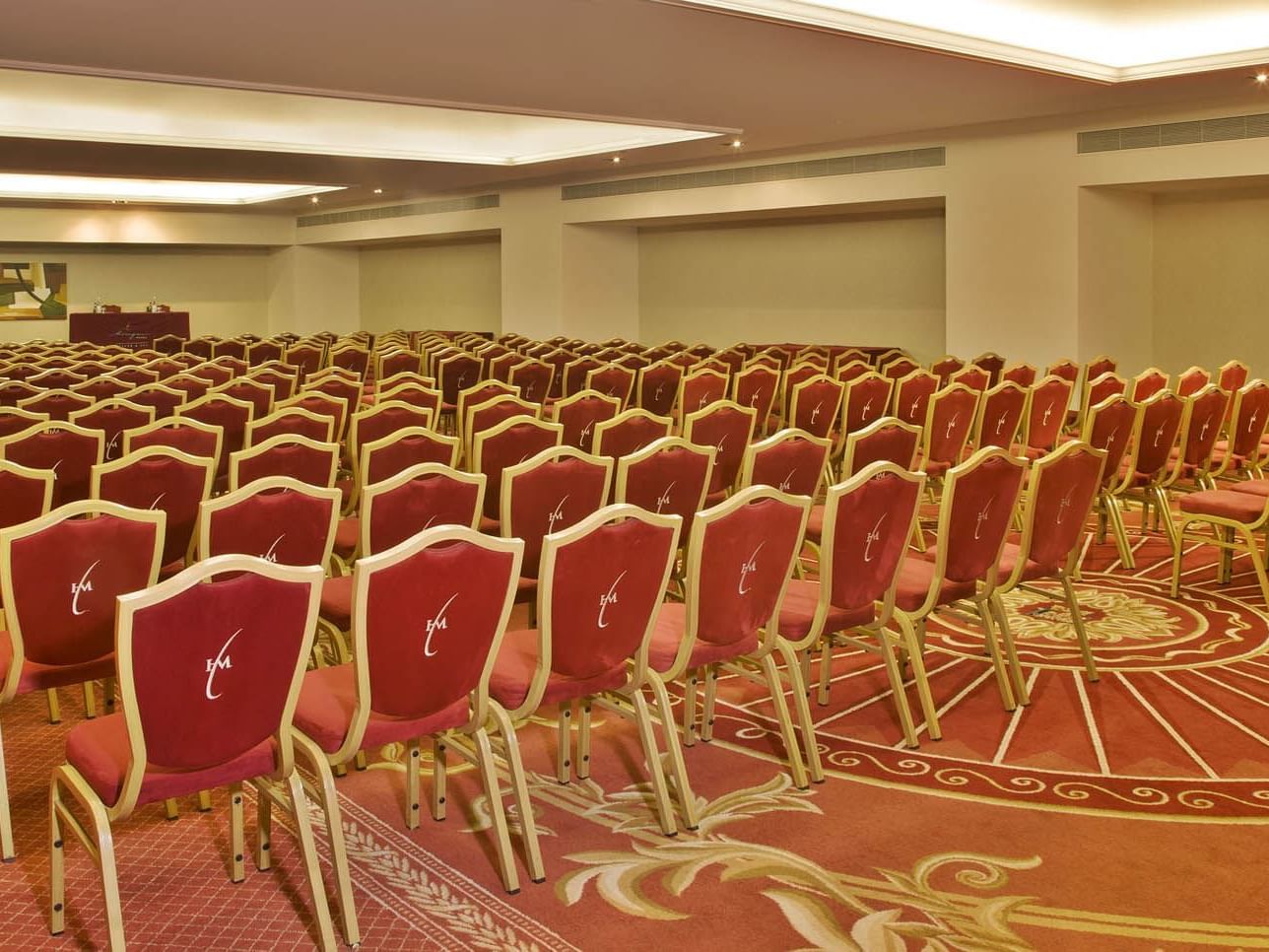 Room with alot of red and gold chairs at Hotel Cascais Miragem