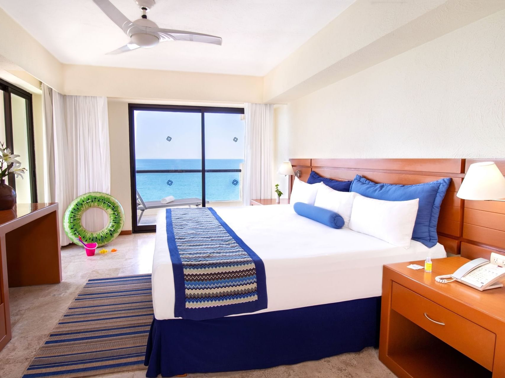 Nightstand by the bed in 2 Bedroom Family Suite, Ocean View at Plaza Pelicanos Grand Beach Resort