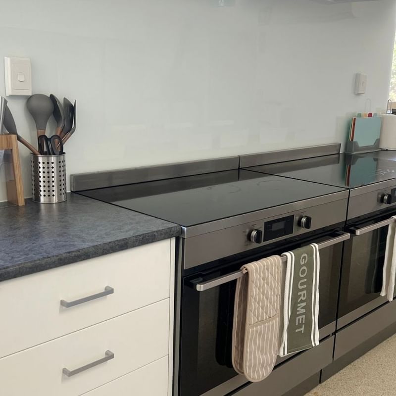 La Trobe University - Orde House kitchen with black oven, white cabinets, and Gourmet towels.