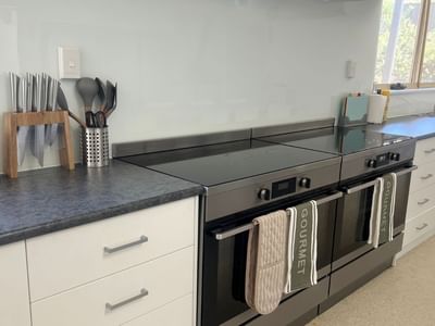 La Trobe University - Orde House kitchen with black oven, white cabinets, and Gourmet towels.