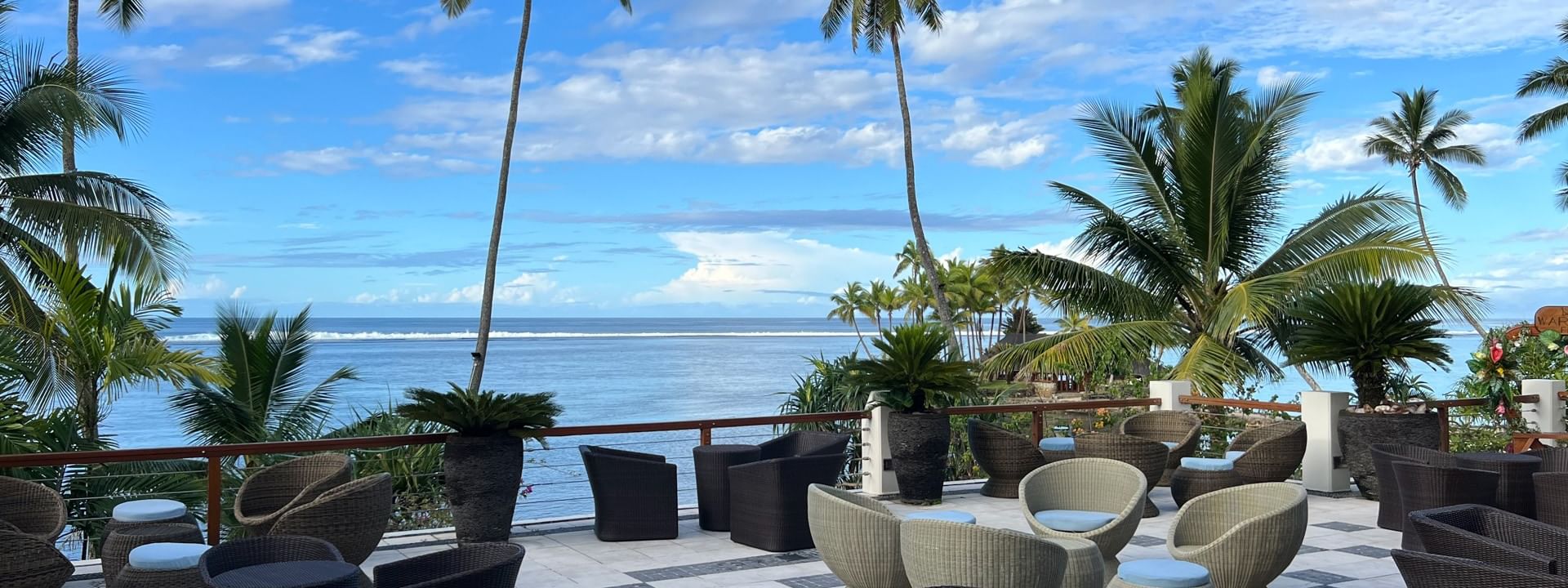 Outdoor seating area with ocean view at Sunset Terrace Bar at Warwick Fiji Resort and Spa, Korolevu