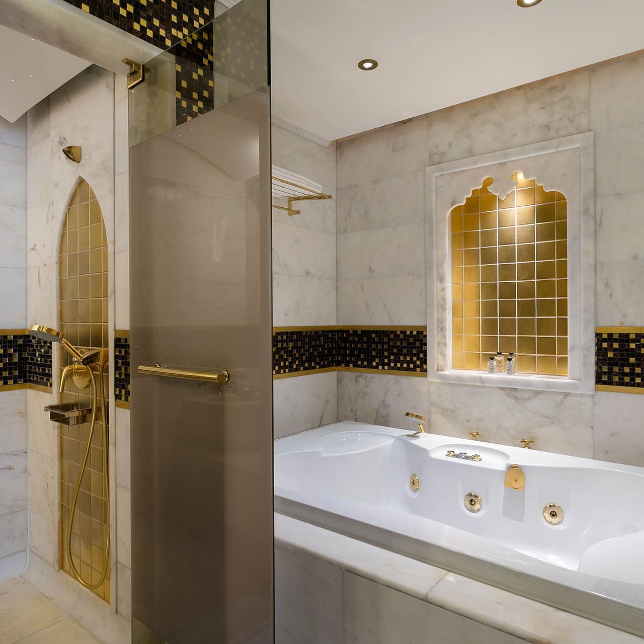 Bathtub and shower area in Deluxe Room at Titanic Mardan Palace