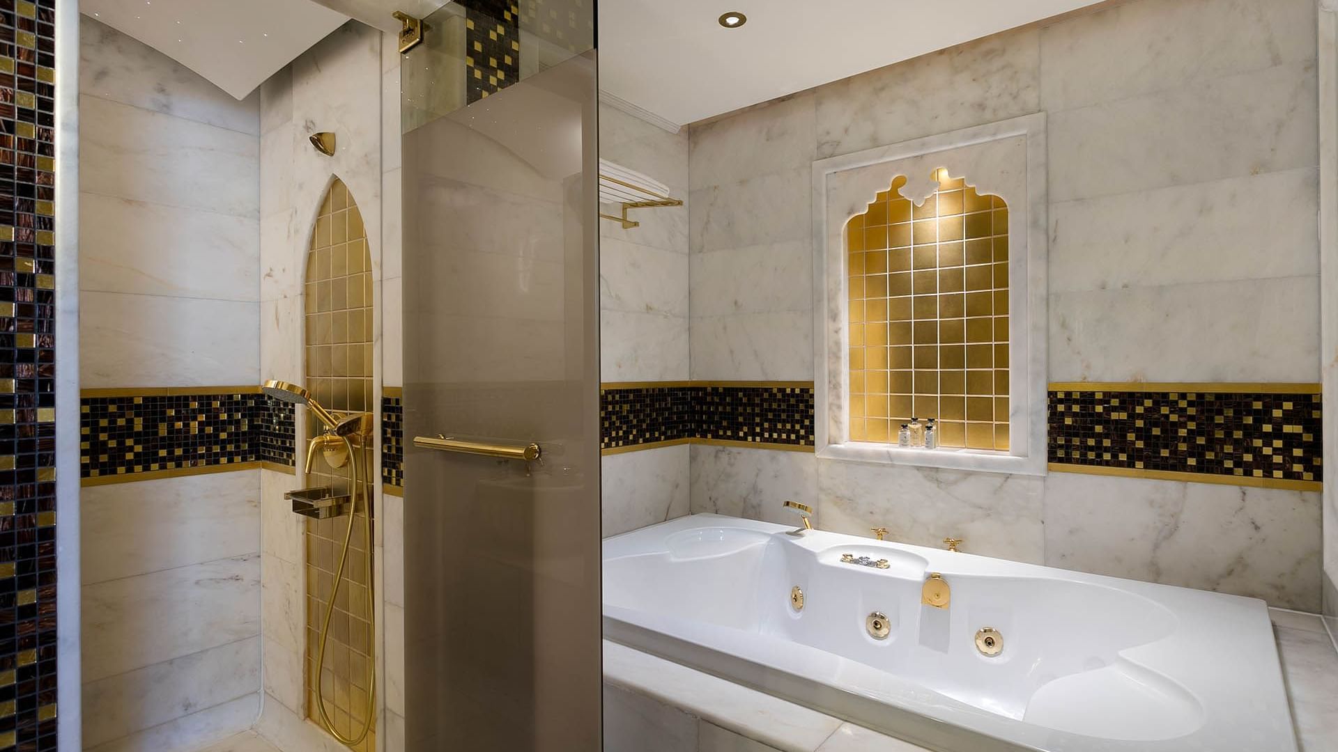 Bathtub and shower area in Deluxe Room at Titanic Mardan Palace