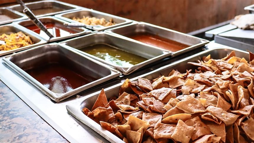 Bufé con totopos crujientes junto a bandejas metálicas de salsas calientes en La Pérgola de Araiza Palmira 