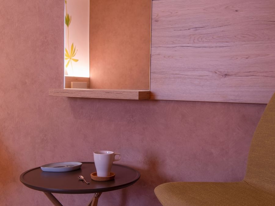 Cup of coffee in pink interior at Hostellerie du Peiffeschof