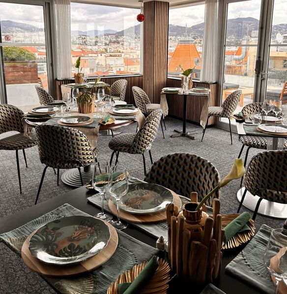 The Jungle Restaurant interior with patterned chairs and elegant table place settings at Splendid Hotel & Spa Nice
