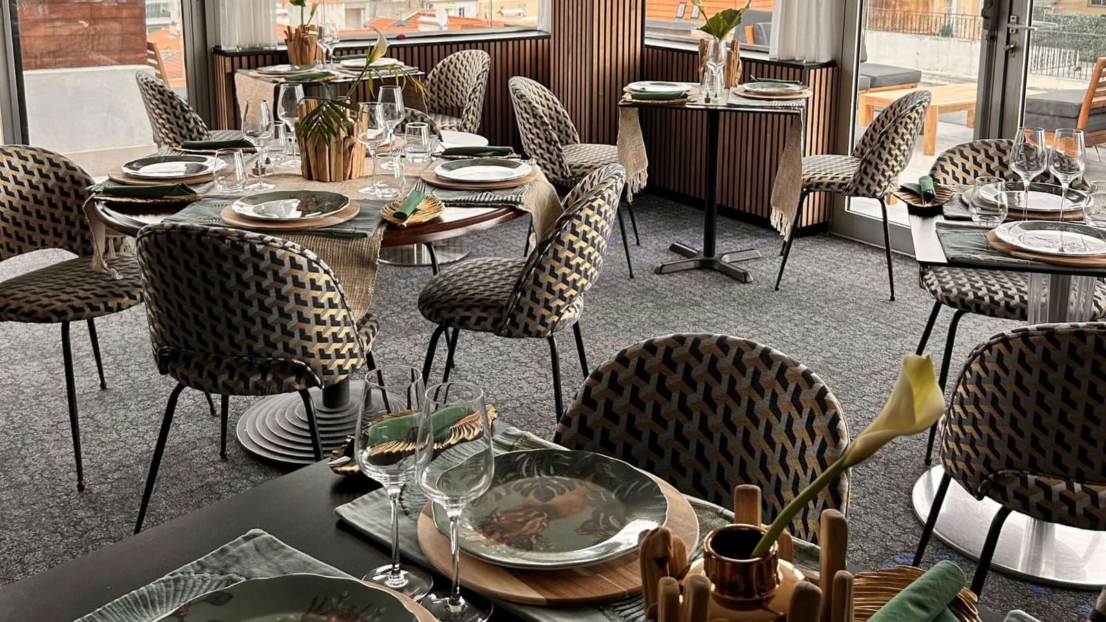 The Jungle Restaurant interior with patterned chairs and elegant table place settings at Splendid Hotel & Spa Nice